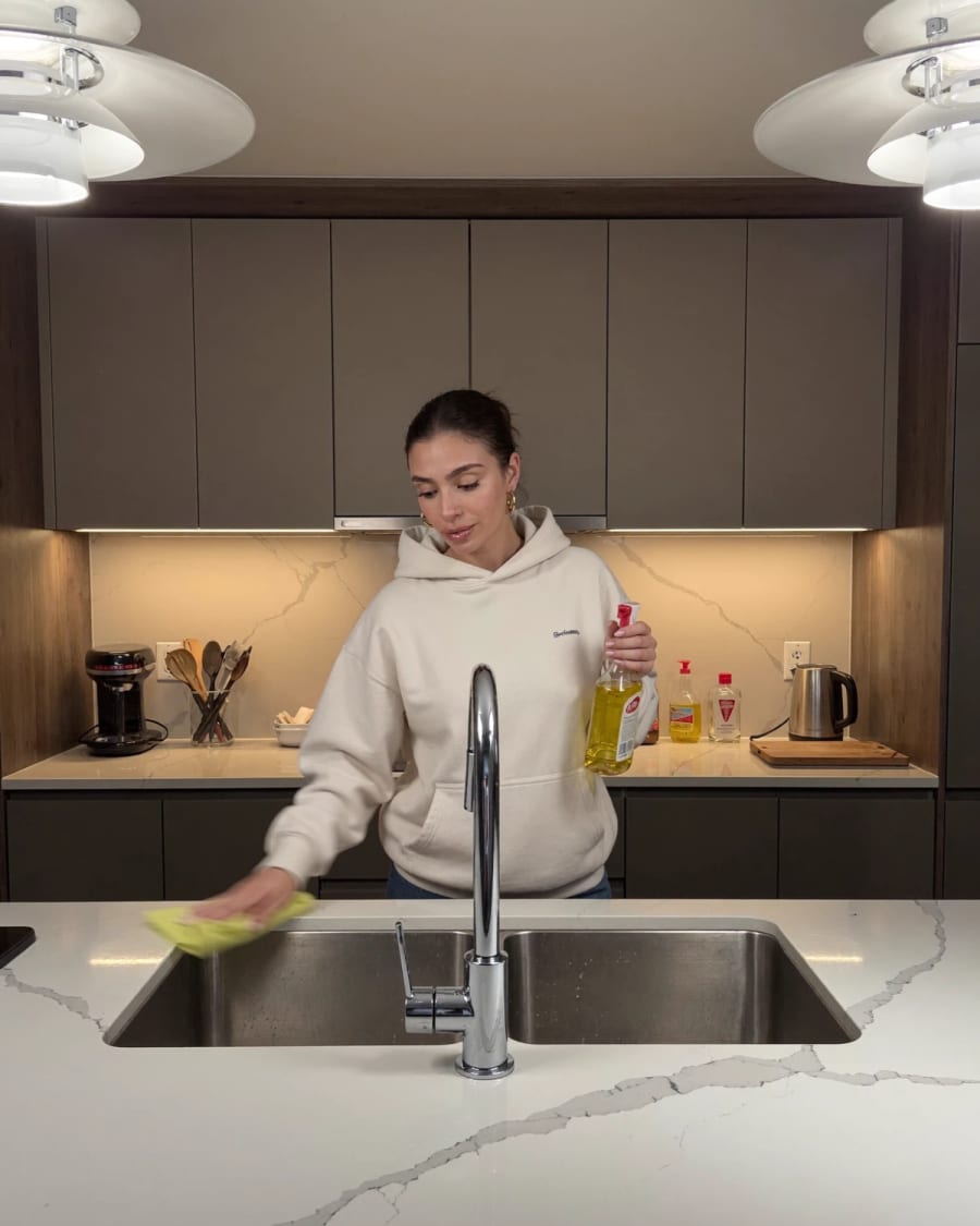 Jenn Hernandez wiping down a kitchen island